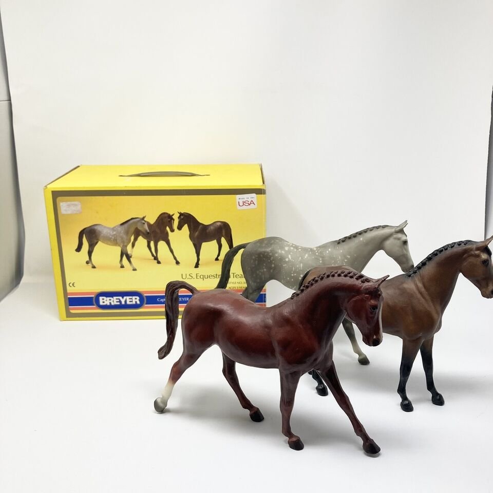 A special run Breyer USET set with a chestnut, a bay, and a dapple gray hrose in front of their vintage yellow box